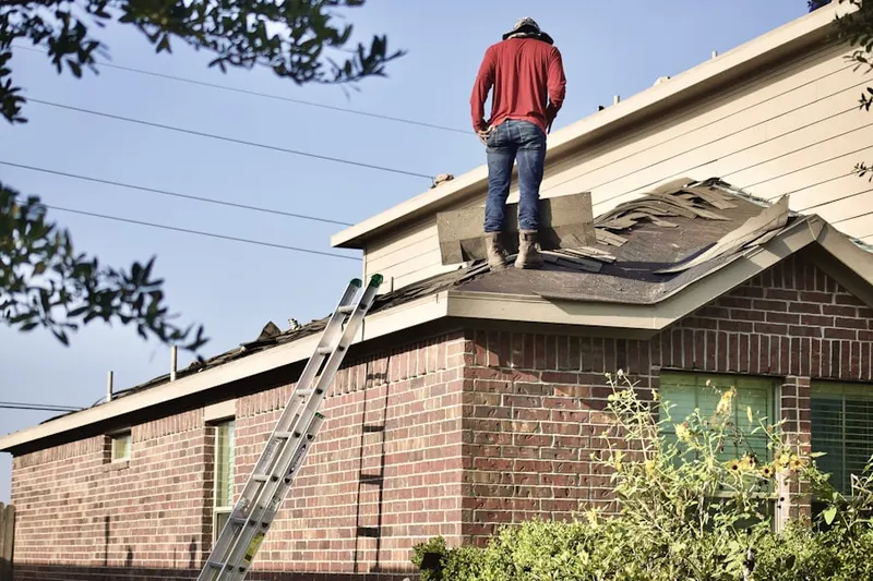Professional roofer working on a residential roof in Caddo Park